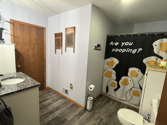 bathroom with vanity, hardwood / wood-style floors, a shower with curtain, and toilet