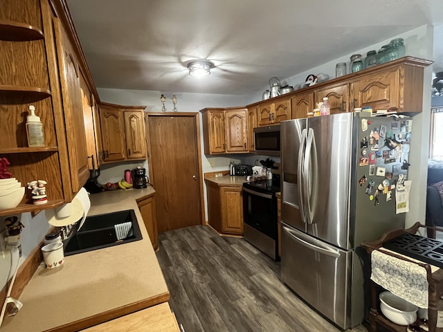 kitchen featuring appliances with stainless steel finishes and dark hardwood / wood-style floors