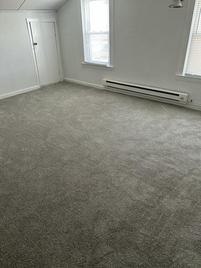 additional living space with baseboard heating and carpet floors