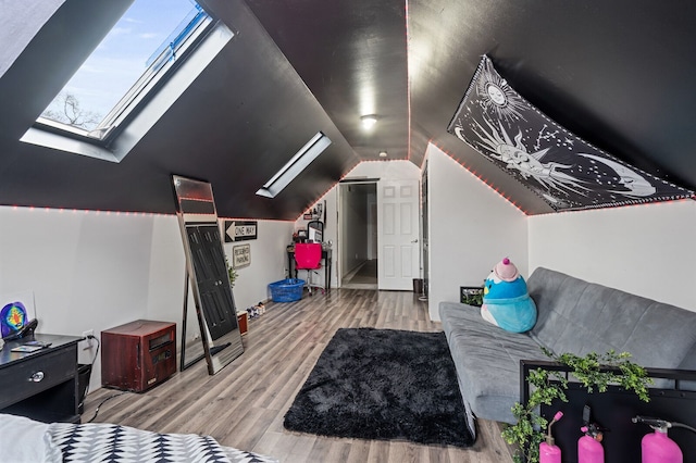 additional living space featuring lofted ceiling with skylight and light wood-type flooring