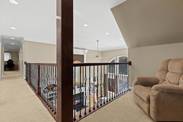 hallway with light carpet and ornamental molding