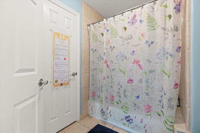 bathroom featuring tile patterned floors and shower / bath combo with shower curtain