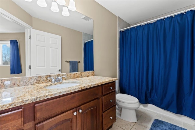 bathroom featuring vanity, tile patterned flooring, and toilet