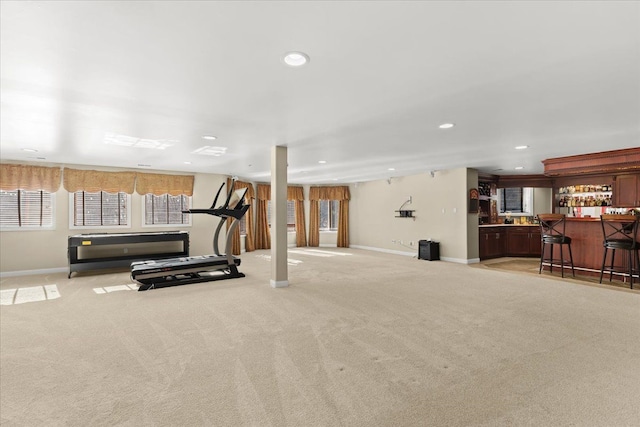 exercise area featuring light colored carpet and bar area