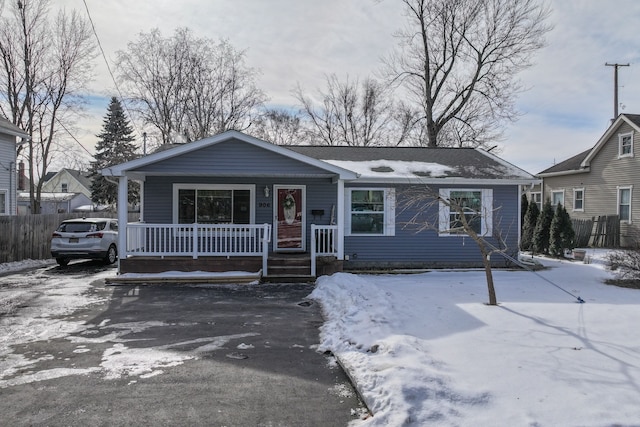 view of front facade with a porch and fence