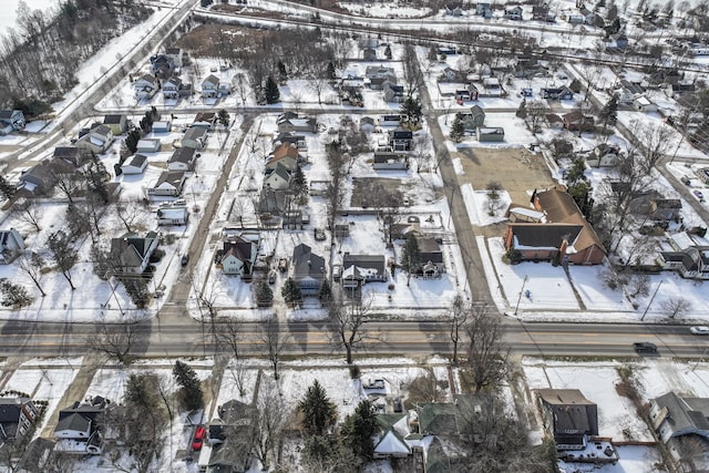 snowy aerial view with a residential view