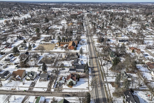 snowy aerial view with a residential view