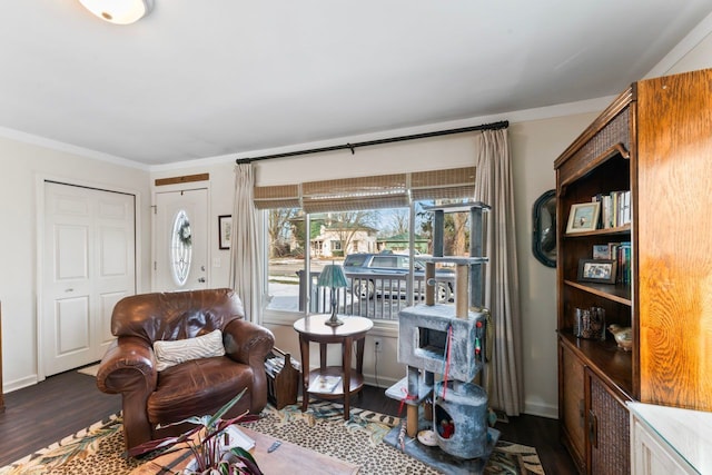 living area featuring crown molding and wood finished floors