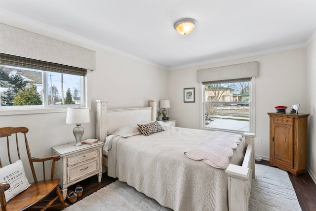 bedroom featuring ornamental molding, dark wood finished floors, and baseboards