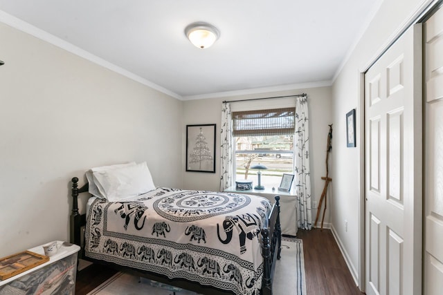 bedroom featuring ornamental molding, dark wood-style flooring, and baseboards