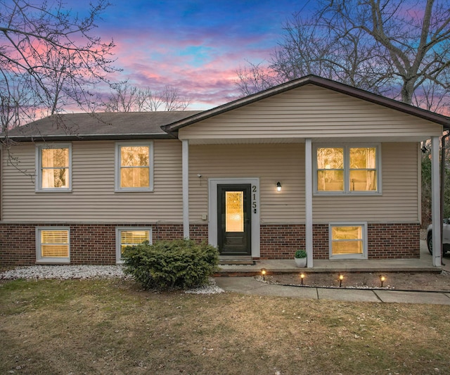 bi-level home with a lawn