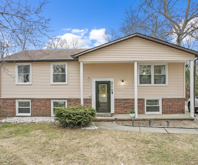 raised ranch with a front yard