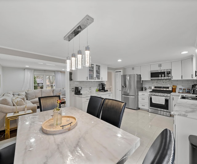 dining space featuring light tile patterned floors and sink