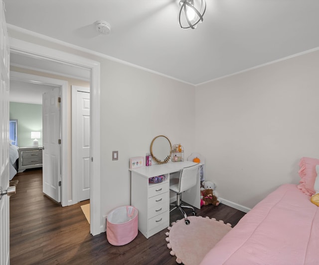 bedroom featuring crown molding and dark hardwood / wood-style floors