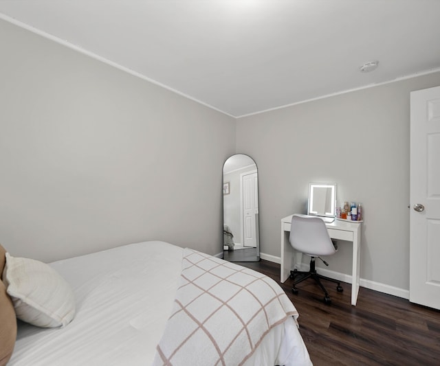 bedroom with dark hardwood / wood-style flooring