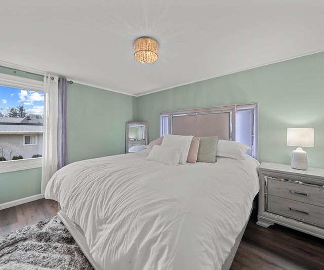 bedroom with dark hardwood / wood-style flooring