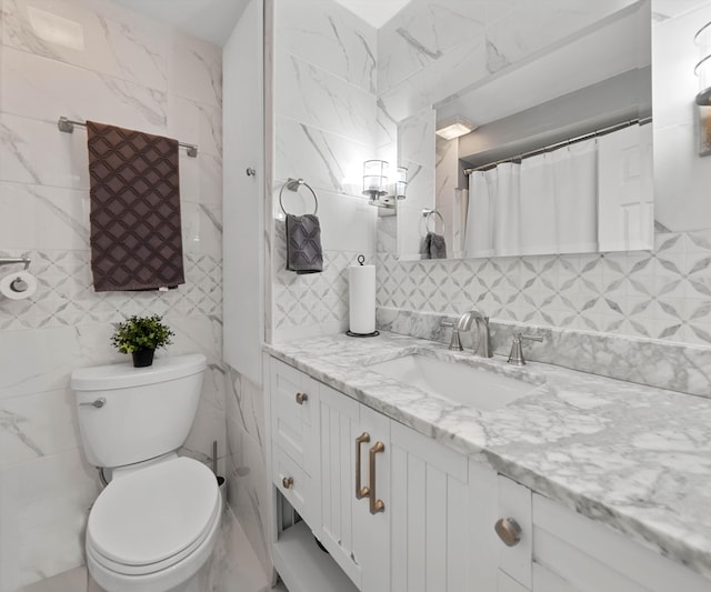 bathroom featuring tile walls, backsplash, vanity, a shower with curtain, and toilet