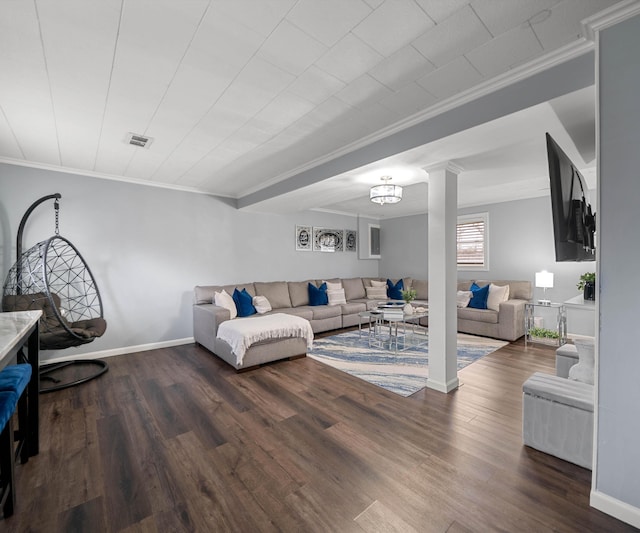 living room with dark wood-type flooring, ornamental molding, and decorative columns