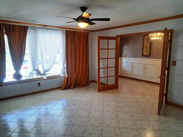 spare room with ceiling fan and ornamental molding