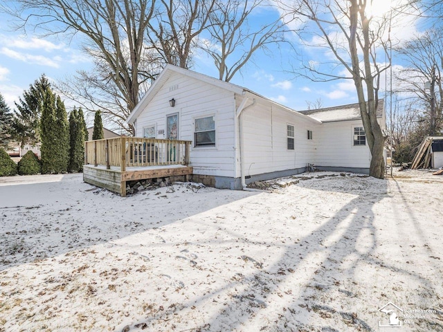 snow covered house with a deck