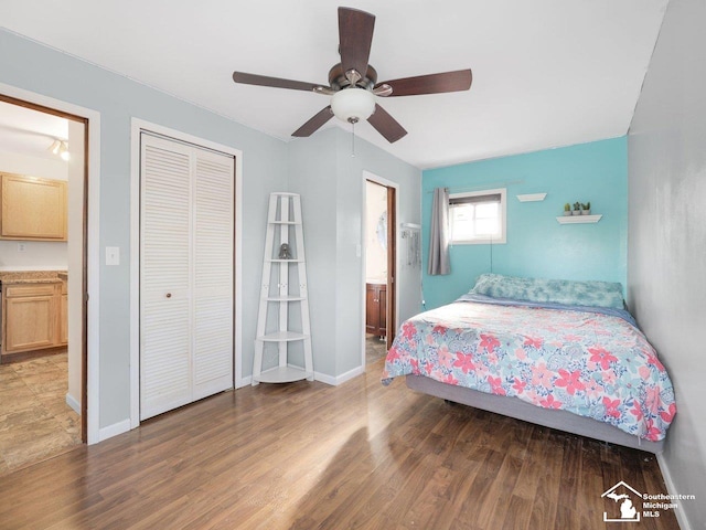 bedroom featuring hardwood / wood-style flooring, ceiling fan, connected bathroom, and a closet