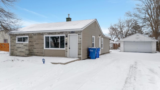 view of front facade with a garage and an outbuilding