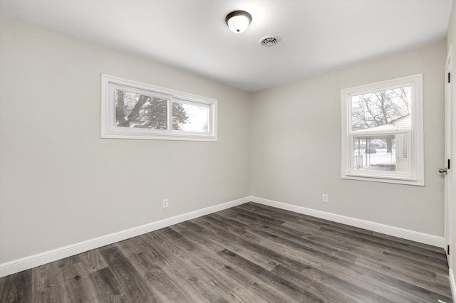 spare room with dark wood-type flooring