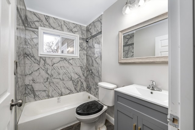 full bathroom with tiled shower / bath combo, vanity, and toilet