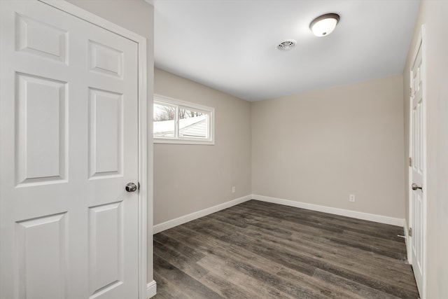 unfurnished bedroom featuring dark hardwood / wood-style flooring