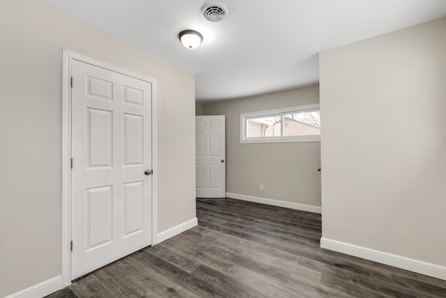 spare room featuring dark wood-type flooring