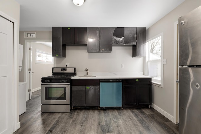 kitchen with stainless steel appliances, wood-type flooring, sink, and a wealth of natural light