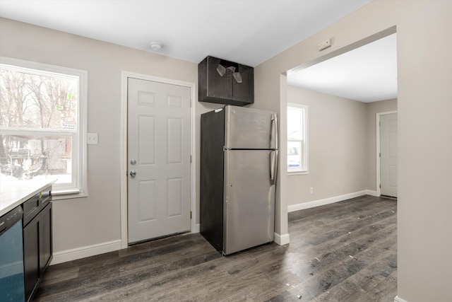 kitchen featuring dark wood-type flooring, stainless steel fridge, and black dishwasher