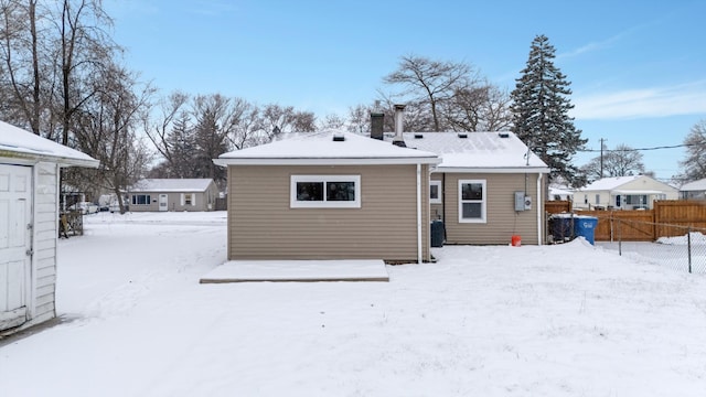 snow covered rear of property with central air condition unit