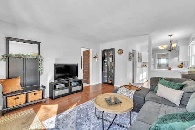 living room featuring hardwood / wood-style flooring and a notable chandelier