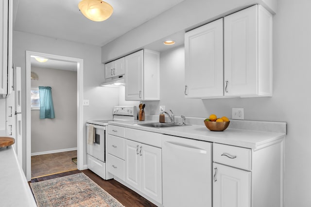 kitchen with white cabinetry, sink, white appliances, and dark hardwood / wood-style flooring