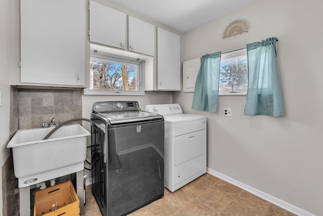 laundry room with separate washer and dryer, sink, cabinets, and a healthy amount of sunlight