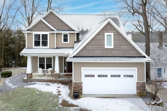 craftsman inspired home with a garage and covered porch