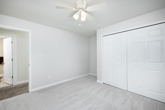 7500 Dexter Pinckney Rd, Dexter, MI 48130 - unfurnished bedroom with ceiling fan, a closet, light carpet, and a textured ceiling