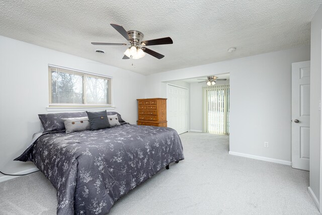 7500 Dexter Pinckney Rd, Dexter, MI 48130 - bedroom with ceiling fan, a closet, light carpet, and a textured ceiling