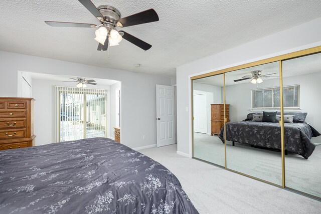 7500 Dexter Pinckney Rd, Dexter, MI 48130 - bedroom with ceiling fan, light colored carpet, a closet, and a textured ceiling