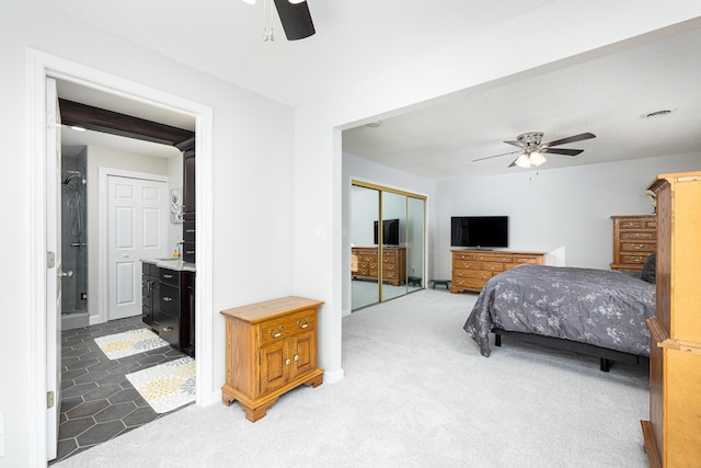 7500 Dexter Pinckney Rd, Dexter, MI 48130 - bedroom featuring ceiling fan, ensuite bath, a closet, and dark colored carpet