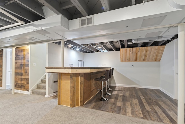 bar with dark hardwood / wood-style flooring