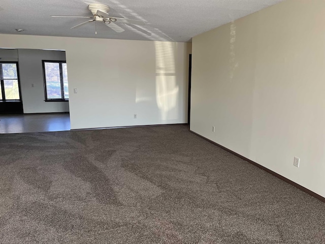 carpeted empty room with ceiling fan and a textured ceiling