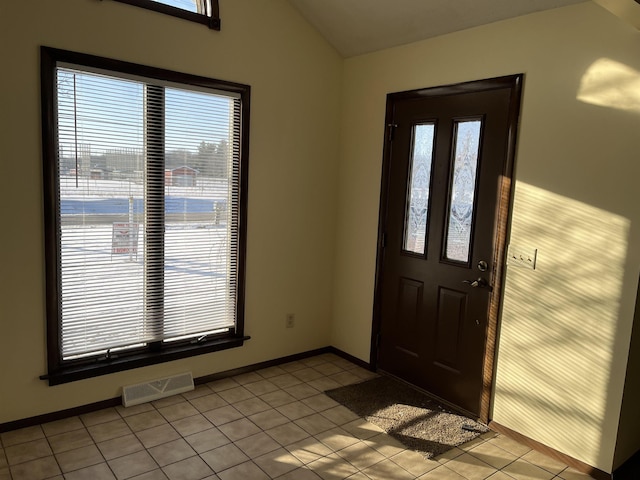 tiled foyer featuring lofted ceiling