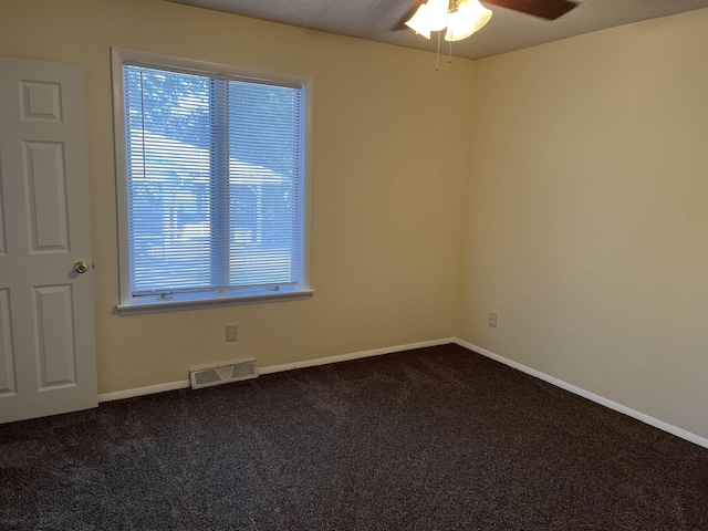 carpeted spare room featuring ceiling fan