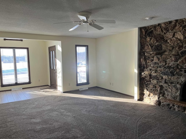 unfurnished room featuring light carpet, ceiling fan, and a textured ceiling