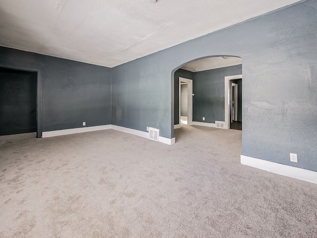 unfurnished room featuring light colored carpet