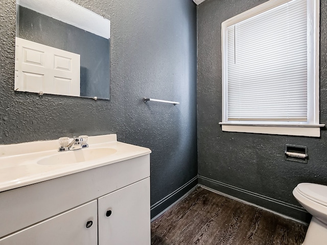 bathroom featuring vanity, hardwood / wood-style flooring, and toilet