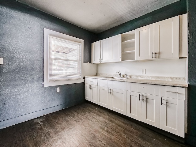 kitchen with sink, white cabinets, and dark hardwood / wood-style floors