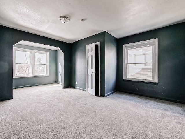 unfurnished bedroom with carpet floors and a textured ceiling